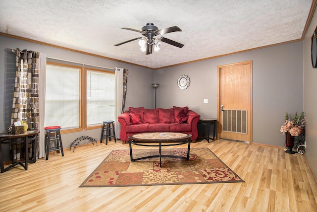 2256 Moulder Dr, Niles, MI 49120 - living area featuring wood finished floors, a ceiling fan, a textured ceiling, and ornamental molding