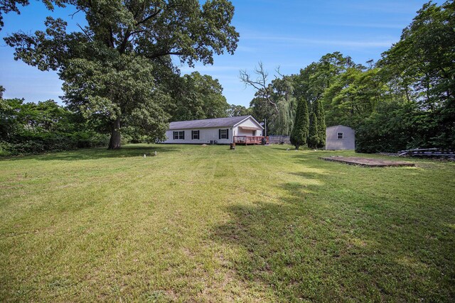 2256 Moulder Dr, Niles, MI 49120 - view of grassy yard featuring a storage shed and a deck