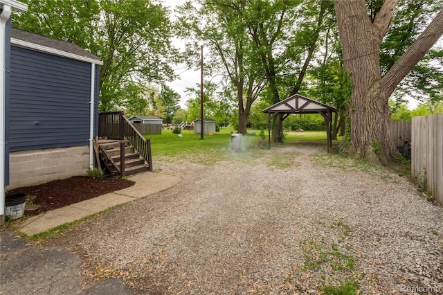 1896 Spaulding Rd, Monroe, MI 48162 - view of yard with a gazebo, a carport, gravel driveway, and a shed