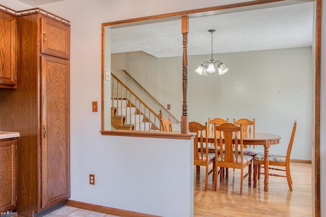 538 Dimmick St, Owosso, MI 48867 - dining area with stairway, a chandelier, and light wood-type flooring