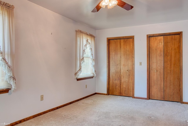538 Dimmick St, Owosso, MI 48867 - unfurnished bedroom featuring two closets, light carpet, and ceiling fan