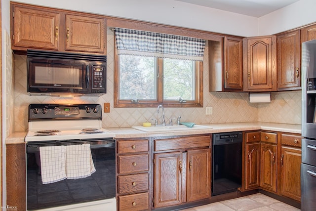 538 Dimmick St, Owosso, MI 48867 - kitchen featuring black appliances, brown cabinets, light countertops, and tasteful backsplash