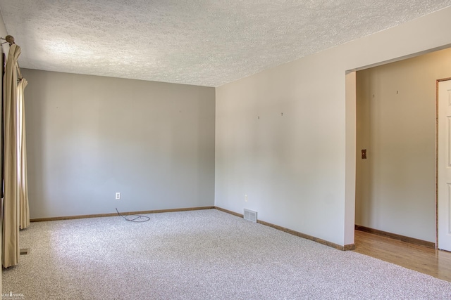 538 Dimmick St, Owosso, MI 48867 - spare room featuring carpet and a textured ceiling