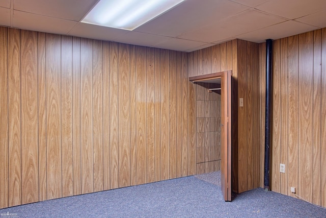 538 Dimmick St, Owosso, MI 48867 - finished basement featuring a paneled ceiling, carpet flooring, and wood walls