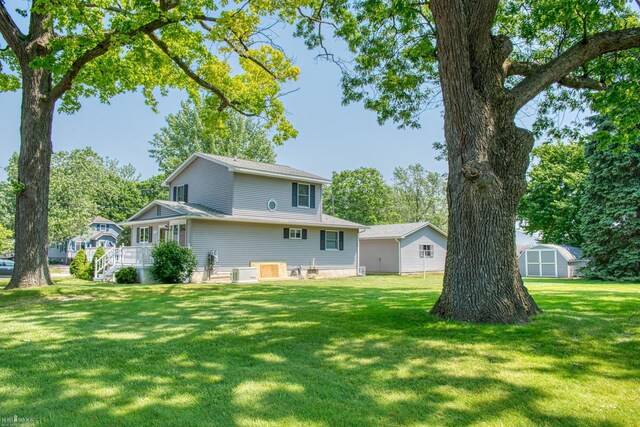 538 Dimmick St, Owosso, MI 48867 - rear view of house with a yard