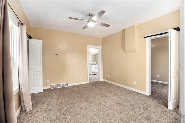 705 E Dowland St, Ludington, MI 49431 - unfurnished bedroom featuring carpet and a ceiling fan