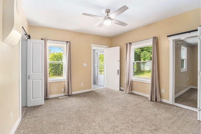 705 E Dowland St, Ludington, MI 49431 - unfurnished bedroom featuring light colored carpet and a ceiling fan