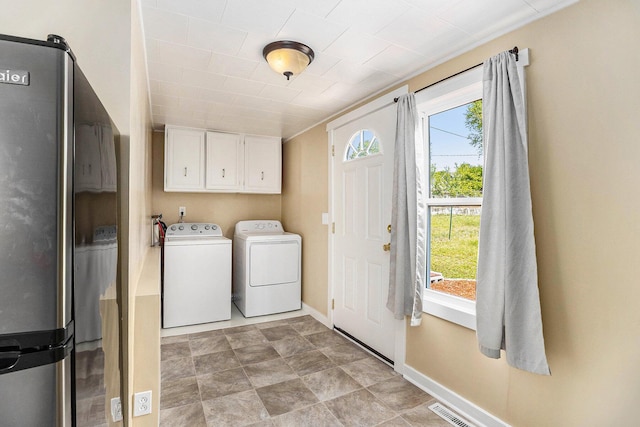 705 E Dowland St, Ludington, MI 49431 - washroom featuring cabinet space and washer and dryer