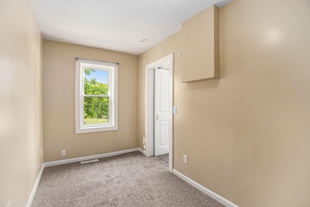 705 E Dowland St, Ludington, MI 49431 - empty room featuring carpet and baseboards