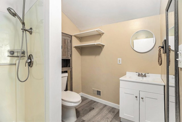 705 E Dowland St, Ludington, MI 49431 - full bath with vanity, wood finished floors, a shower, and lofted ceiling