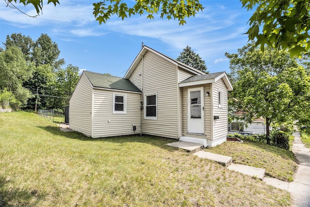 705 E Dowland St, Ludington, MI 49431 - view of front of property with a front yard and roof with shingles
