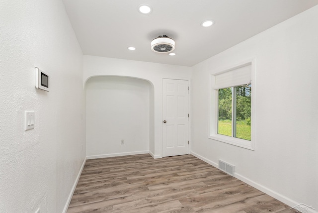 2411 Sheridan Ave, Saginaw, MI 48601 - empty room featuring recessed lighting, light wood-style floors, and arched walkways