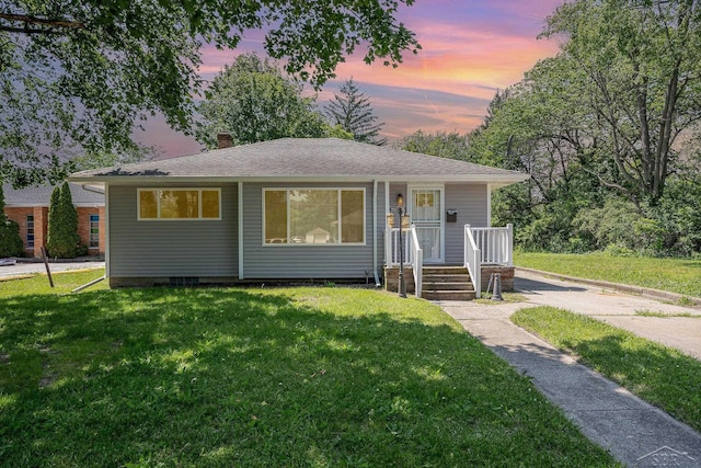 2411 Sheridan Ave, Saginaw, MI 48601 - bungalow-style home featuring a front lawn, a chimney, and a shingled roof