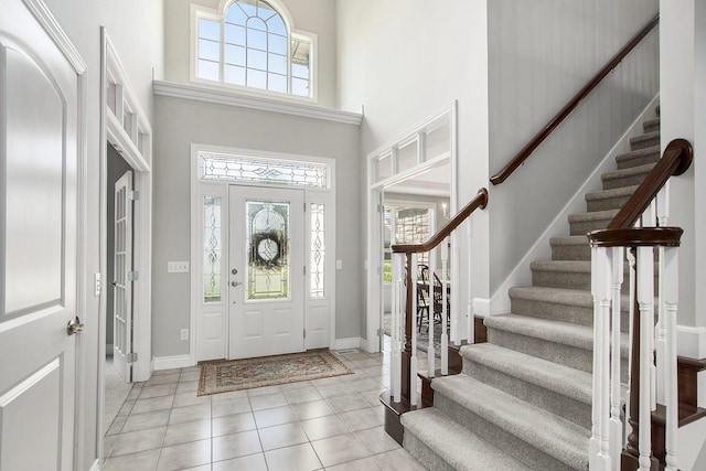 7251 Beverly Dr, South Haven, MI 49090 - foyer entrance featuring a high ceiling, plenty of natural light, stairway, and light tile patterned floors