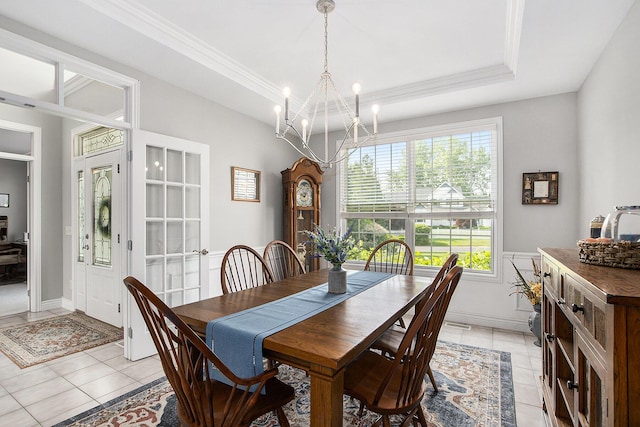 7251 Beverly Dr, South Haven, MI 49090 - dining room featuring a chandelier, a raised ceiling, light tile patterned floors, and crown molding