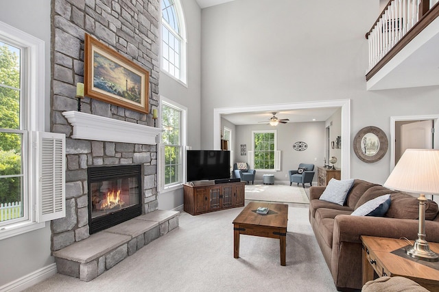 7251 Beverly Dr, South Haven, MI 49090 - living room with a fireplace, light carpet, a high ceiling, and ceiling fan