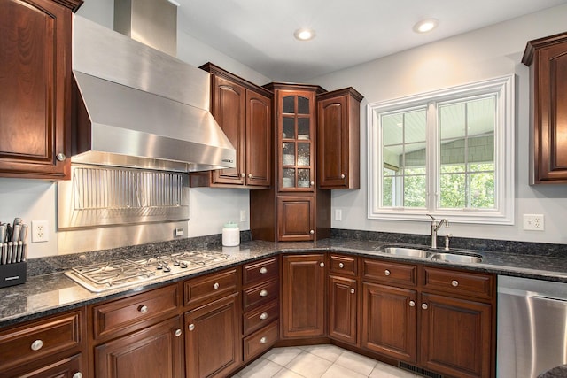 7251 Beverly Dr, South Haven, MI 49090 - kitchen with appliances with stainless steel finishes, wall chimney exhaust hood, dark stone countertops, glass insert cabinets, and light tile patterned flooring
