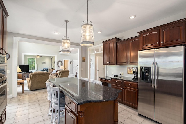 7251 Beverly Dr, South Haven, MI 49090 - kitchen with stainless steel fridge, open floor plan, a center island, dark stone countertops, and light tile patterned floors