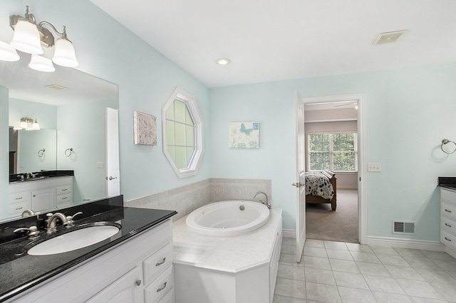 7251 Beverly Dr, South Haven, MI 49090 - bathroom with two vanities, a bath, ensuite bath, and tile patterned floors