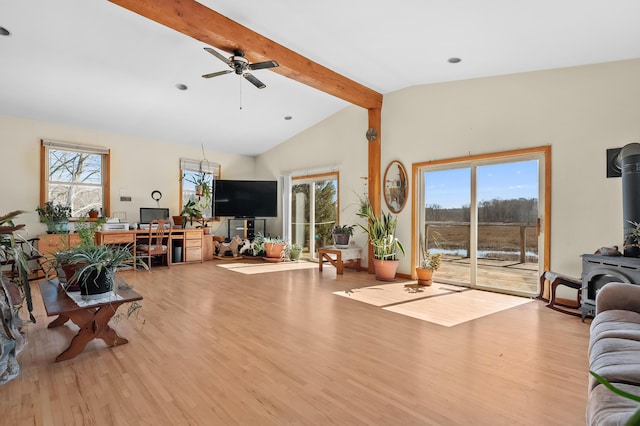 7350 Cedar Creek Rd, Delton, MI 49046 - living area with a wood stove, wood finished floors, healthy amount of natural light, and a ceiling fan