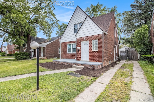 18504 Sussex St, Detroit, MI 48235 - bungalow with brick siding, driveway, a shingled roof, and a gate
