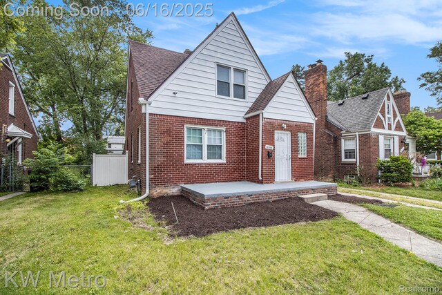 18504 Sussex St, Detroit, MI 48235 - view of front facade with brick siding, roof with shingles, and a chimney