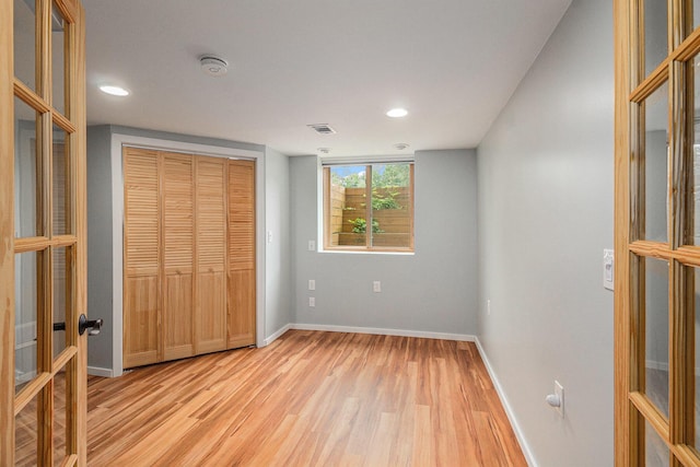 8175 Chamberlin Rd, Dexter, MI 48130 - unfurnished bedroom with light wood finished floors, recessed lighting, a closet, and french doors