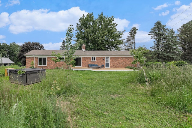 8175 Chamberlin Rd, Dexter, MI 48130 - back of house featuring brick siding, a patio, a chimney, and a lawn
