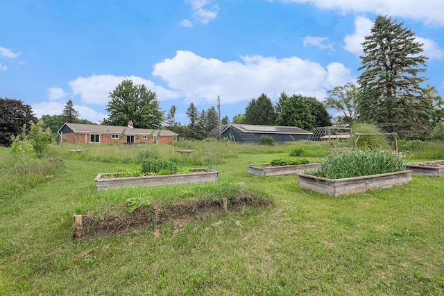 8175 Chamberlin Rd, Dexter, MI 48130 - view of green lawn featuring a vegetable garden
