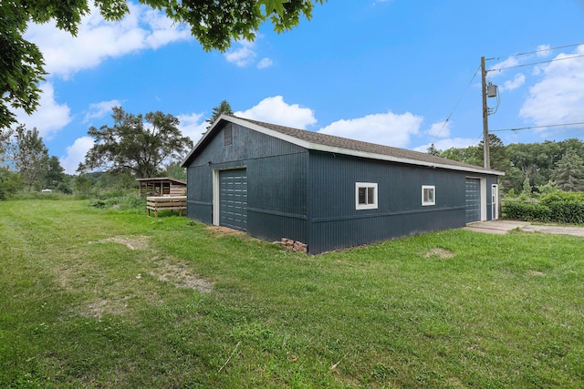 8175 Chamberlin Rd, Dexter, MI 48130 - view of property exterior featuring a yard, an outbuilding, and a detached garage