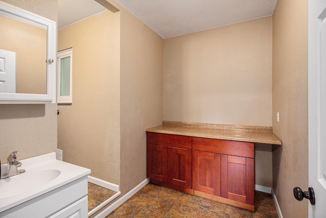 8175 Chamberlin Rd, Dexter, MI 48130 - bathroom featuring vanity and baseboards