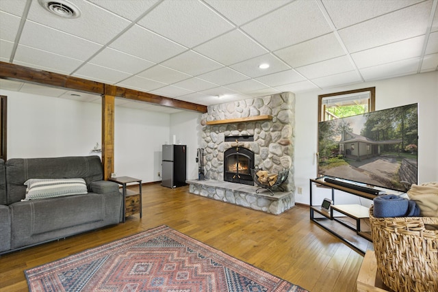 6860 Ashley Ave NE, Belding, MI 48809 - living room with wood finished floors, a drop ceiling, a stone fireplace, and recessed lighting