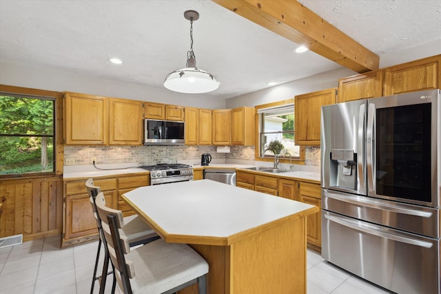 6860 Ashley Ave NE, Belding, MI 48809 - kitchen featuring appliances with stainless steel finishes, light countertops, light tile patterned flooring, tasteful backsplash, and beam ceiling