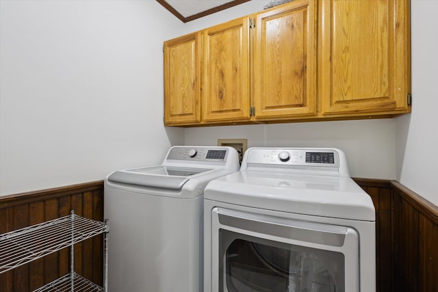 6860 Ashley Ave NE, Belding, MI 48809 - laundry room with washing machine and dryer, wainscoting, cabinet space, and wooden walls