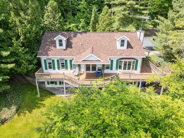 6860 Ashley Ave NE, Belding, MI 48809 - rear view of house featuring a wooden deck, a chimney, a shingled roof, and a lawn