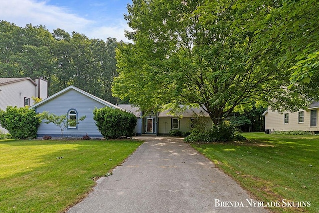 13412 Forest Park Dr, Grand Haven, MI 49417 - view of front of house with a front lawn and asphalt driveway