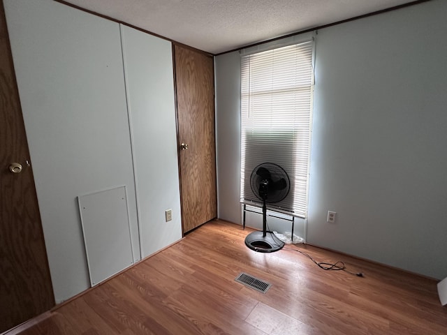 5355 Meadowmoor Dr NE, Belmont, MI 49306 - washroom with light wood-style floors and a textured ceiling