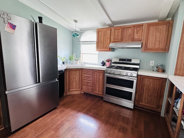 5355 Meadowmoor Dr NE, Belmont, MI 49306 - kitchen with stainless steel appliances, under cabinet range hood, dark wood finished floors, light countertops, and decorative light fixtures