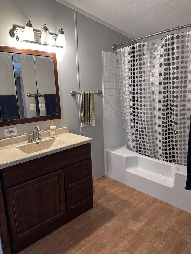 5355 Meadowmoor Dr NE, Belmont, MI 49306 - full bath featuring vanity, shower / tub combo, and wood finished floors