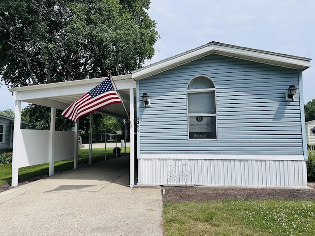 5355 Meadowmoor Dr NE, Belmont, MI 49306 - view of side of property with a carport and concrete driveway