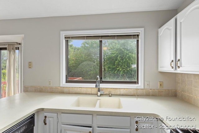 5952 Wind Brook Ave SE, Kentwood, MI 49508 - kitchen featuring dishwasher, white cabinets, light countertops, and decorative backsplash