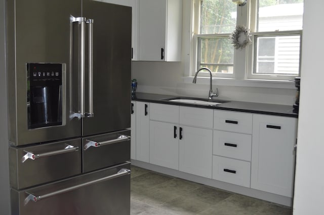 517 Winchester Ave, Saint Joseph, MI 49085 - kitchen with high end refrigerator, dark countertops, and white cabinetry