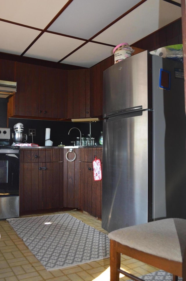 517 Winchester Ave, Saint Joseph, MI 49085 - kitchen featuring appliances with stainless steel finishes, exhaust hood, light floors, and dark brown cabinets