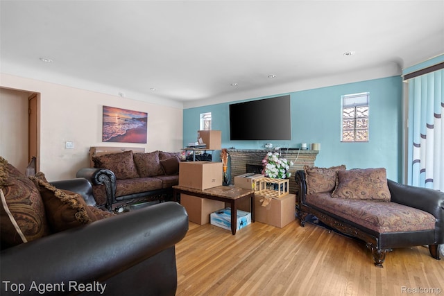 17090 Collinson Ave, Eastpointe, MI 48021 - living room with plenty of natural light, light wood-style floors, recessed lighting, and a brick fireplace