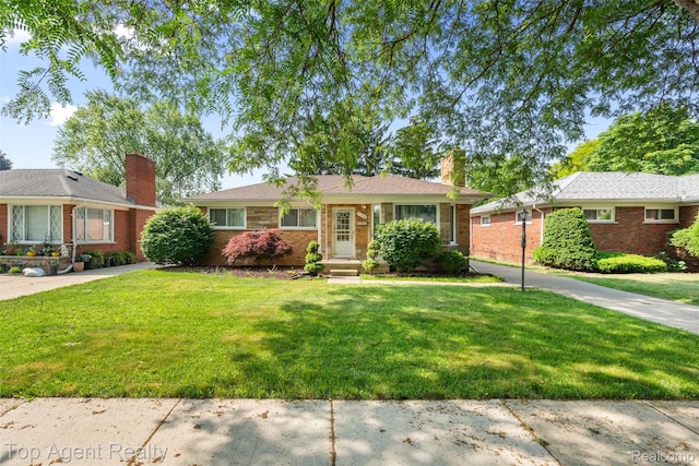 17090 Collinson Ave, Eastpointe, MI 48021 - ranch-style home featuring a chimney, a front yard, and brick siding