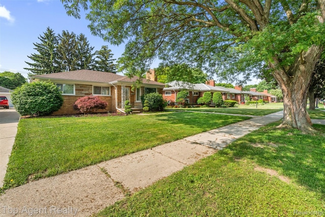 17090 Collinson Ave, Eastpointe, MI 48021 - single story home featuring a chimney, brick siding, and a front yard