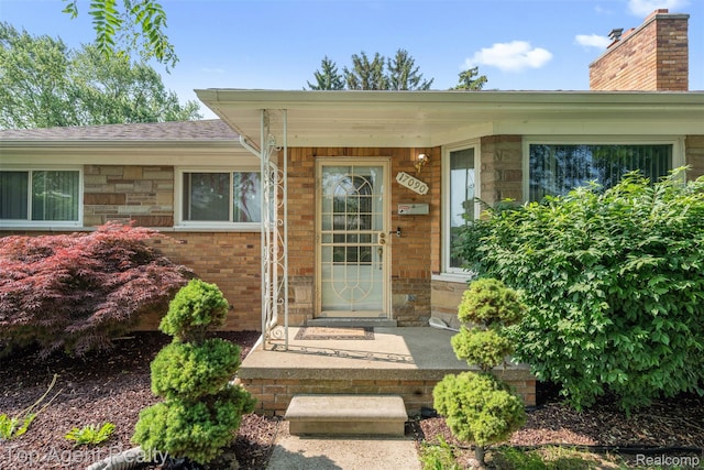 17090 Collinson Ave, Eastpointe, MI 48021 - entrance to property featuring stone siding and a shingled roof