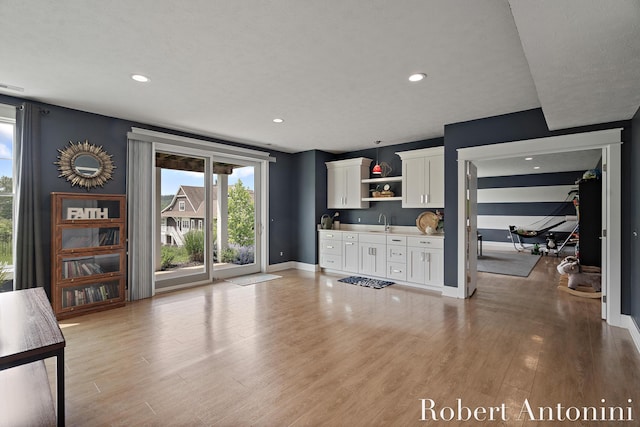 3794 Lake Birch St NE, Grand Rapids, MI 49525 - unfurnished living room with light wood-type flooring and recessed lighting