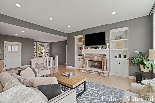 3794 Lake Birch St NE, Grand Rapids, MI 49525 - living room featuring recessed lighting, light wood-style flooring, a fireplace, and built in shelves