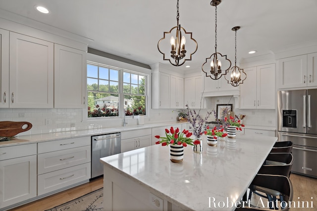 3794 Lake Birch St NE, Grand Rapids, MI 49525 - kitchen featuring stainless steel appliances, a chandelier, white cabinets, backsplash, and recessed lighting